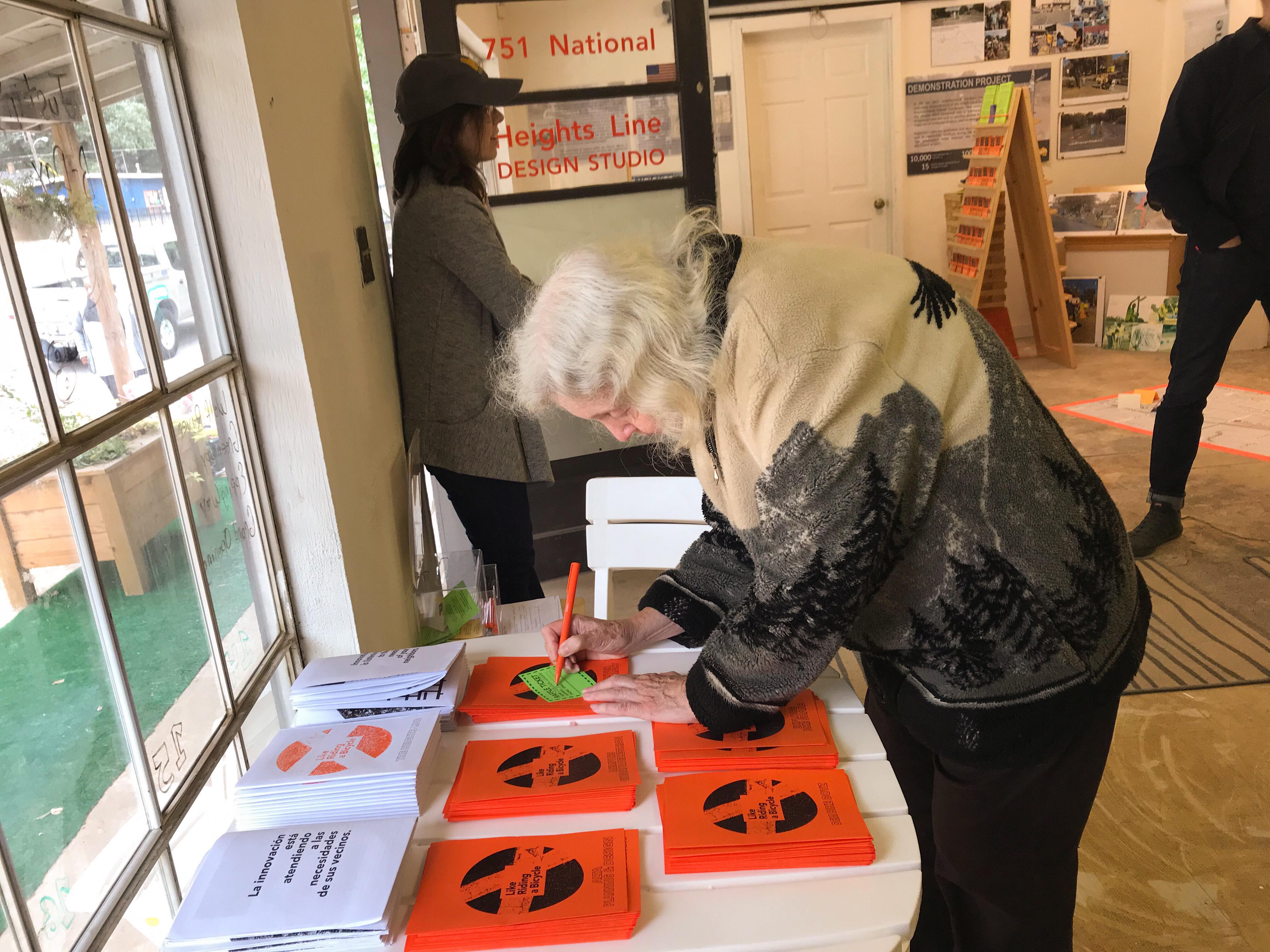 A senior resident of The Heights fills out a raffle ticket at a design studio event. (Cole Bradley)