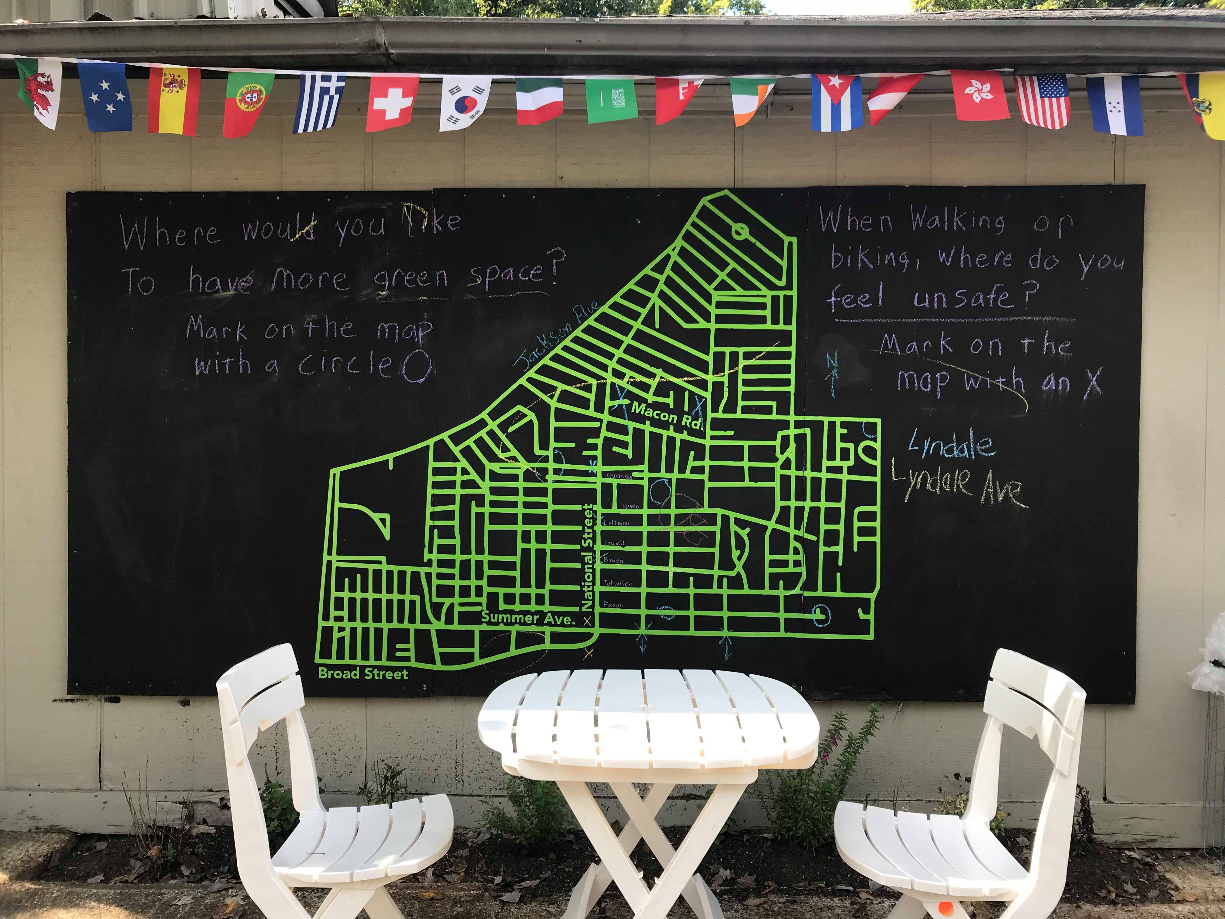 A once-drab building, 751 National Street now has tables and chairs, interactive maps of the neighborhood, and flags denoting the many nationalities in The Heights. (Cole Bradley) 