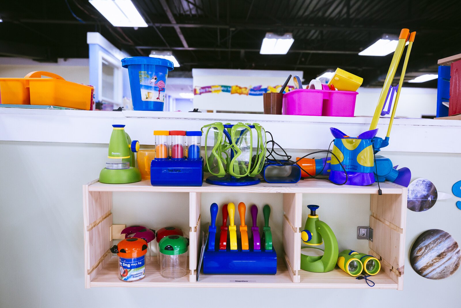 Tools for exploration including microscopes, goggles and collection jars line the shelves of Ready, Set, Grow Learning Academy. The center is STEAM-focused. (Ziggy Mack)