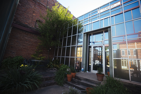 A mirrored exterior at the Rendezvous shipping facility in the Pinch District reflects historic buildings. (Ziggy Mack)