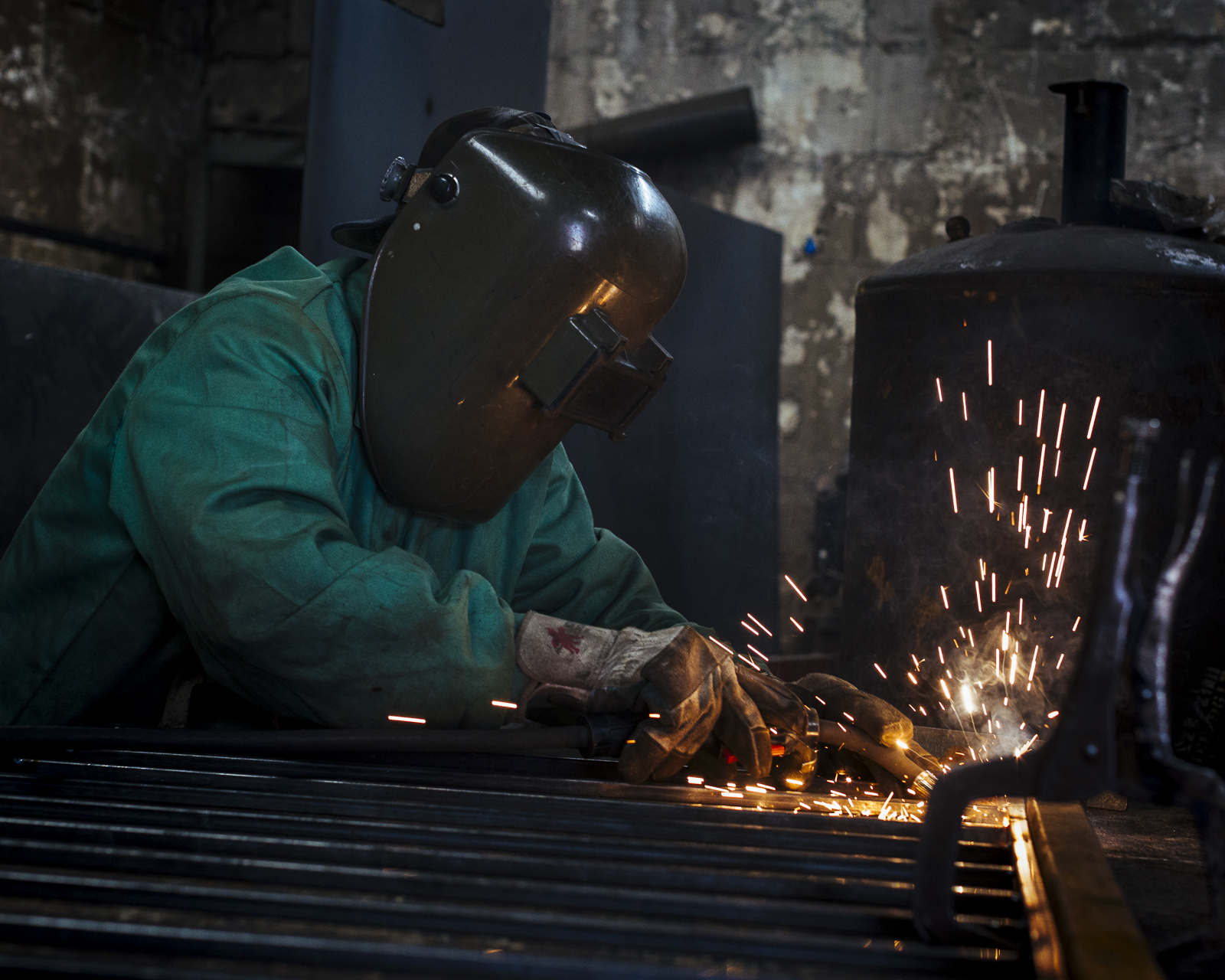 Dwayne "DJ" Johnson's assistant welds security bars for a client at Johnson's shop at 2992 Summer Avenue (Ziggy Mack)