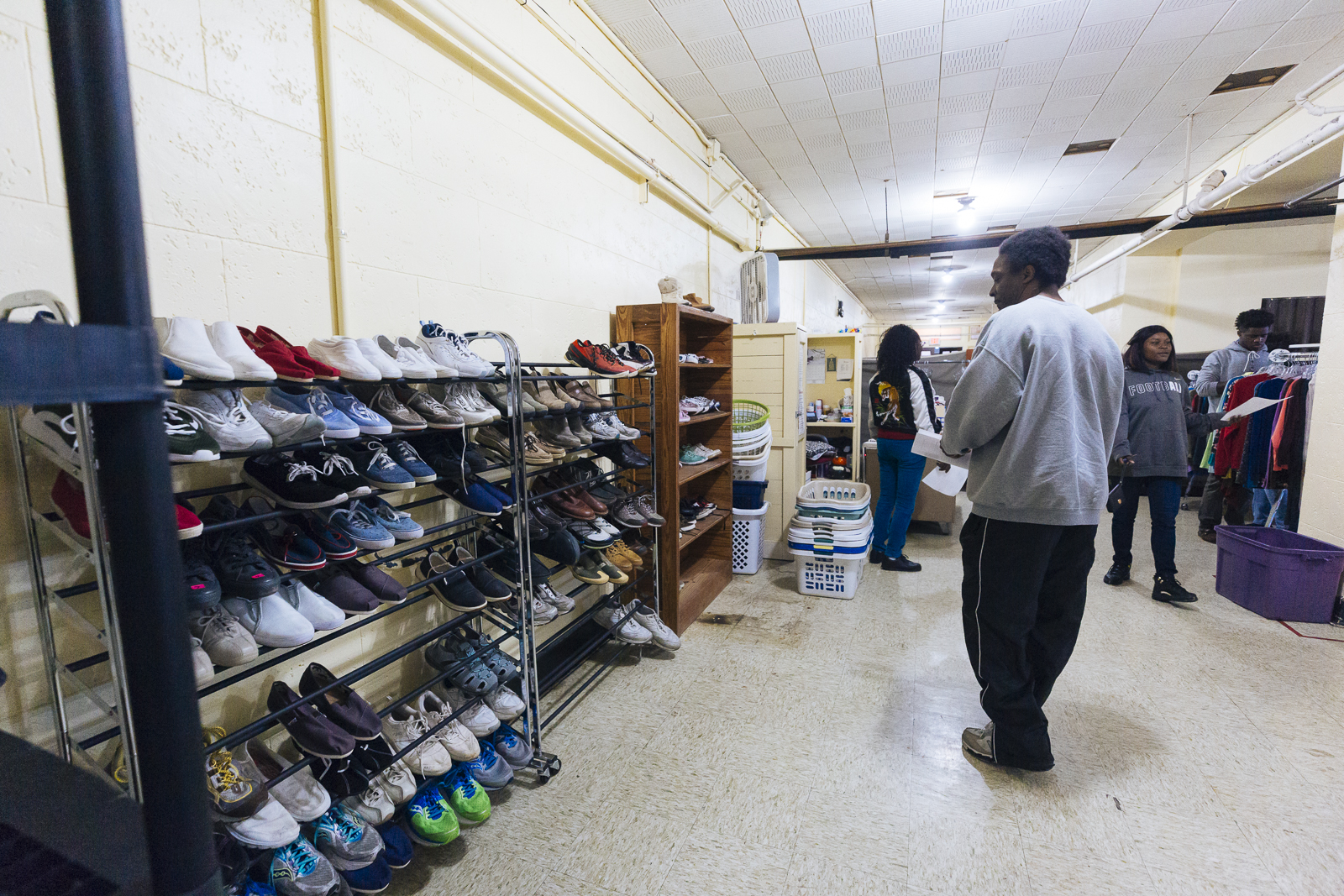 People who are experiencing homelessness collect donated clothing goods at at Catholic Charities, 1325 Jefferson Avenue. (Ziggy Mack) 