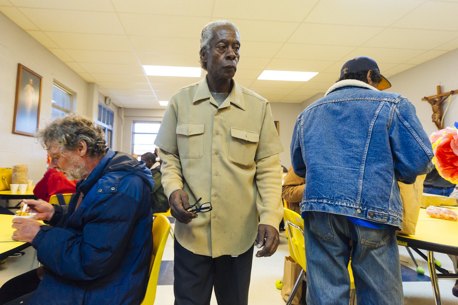 Pastor Jeffrie Howard, center, walks through diners at the Society of St. Vincent de Paul of Memphis's Ozanam Food Mission, March 2019. It was one of two area locations that served hot meals daily. COVID-19 has closed many soup kitchens. (Ziggy Mack)