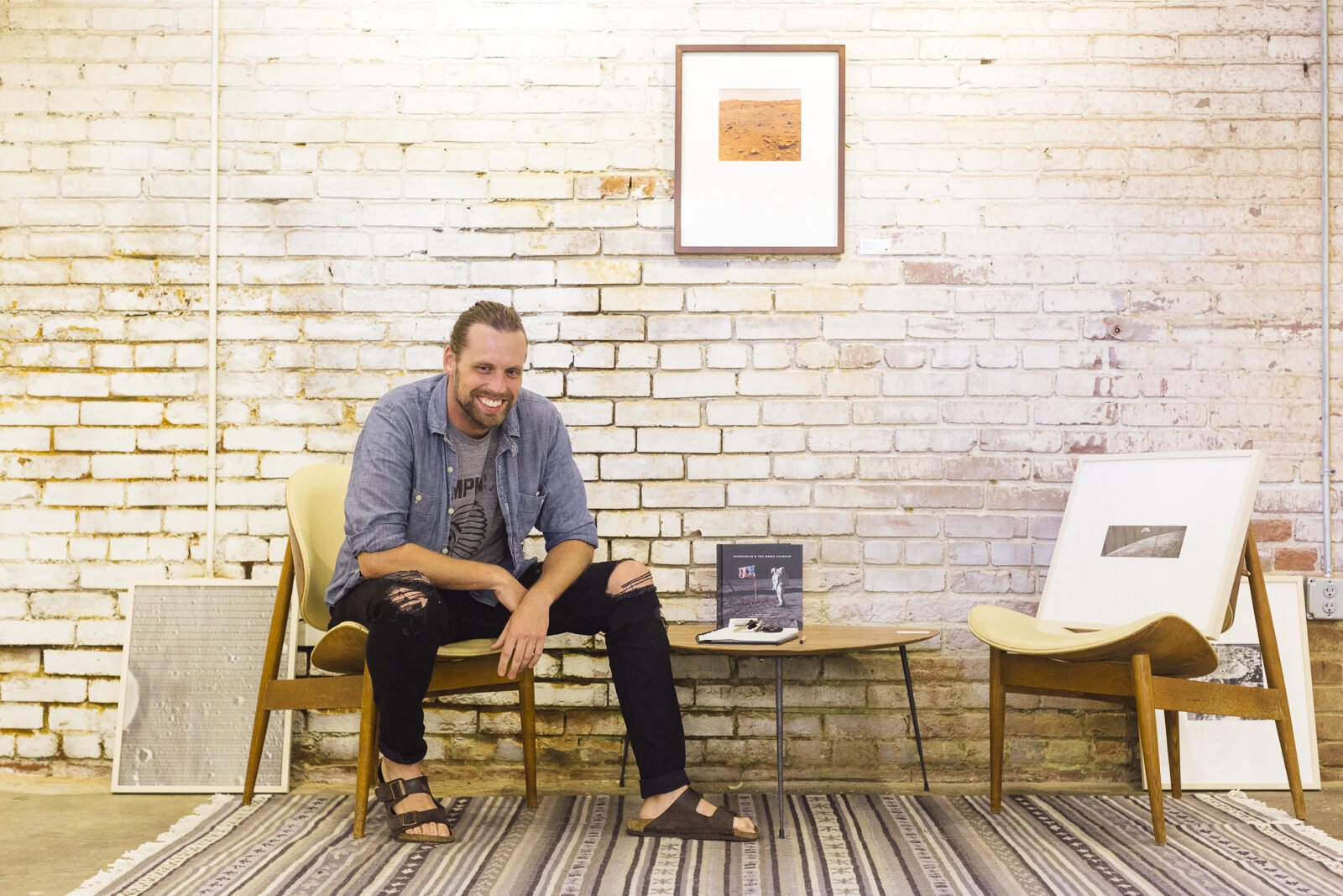 Ryan Adams poses inside Edge Alley, a restaurant in The Edge that is now home to Ryan's Shift + Gallery vintage photography gallery. (Ziggy Mack)