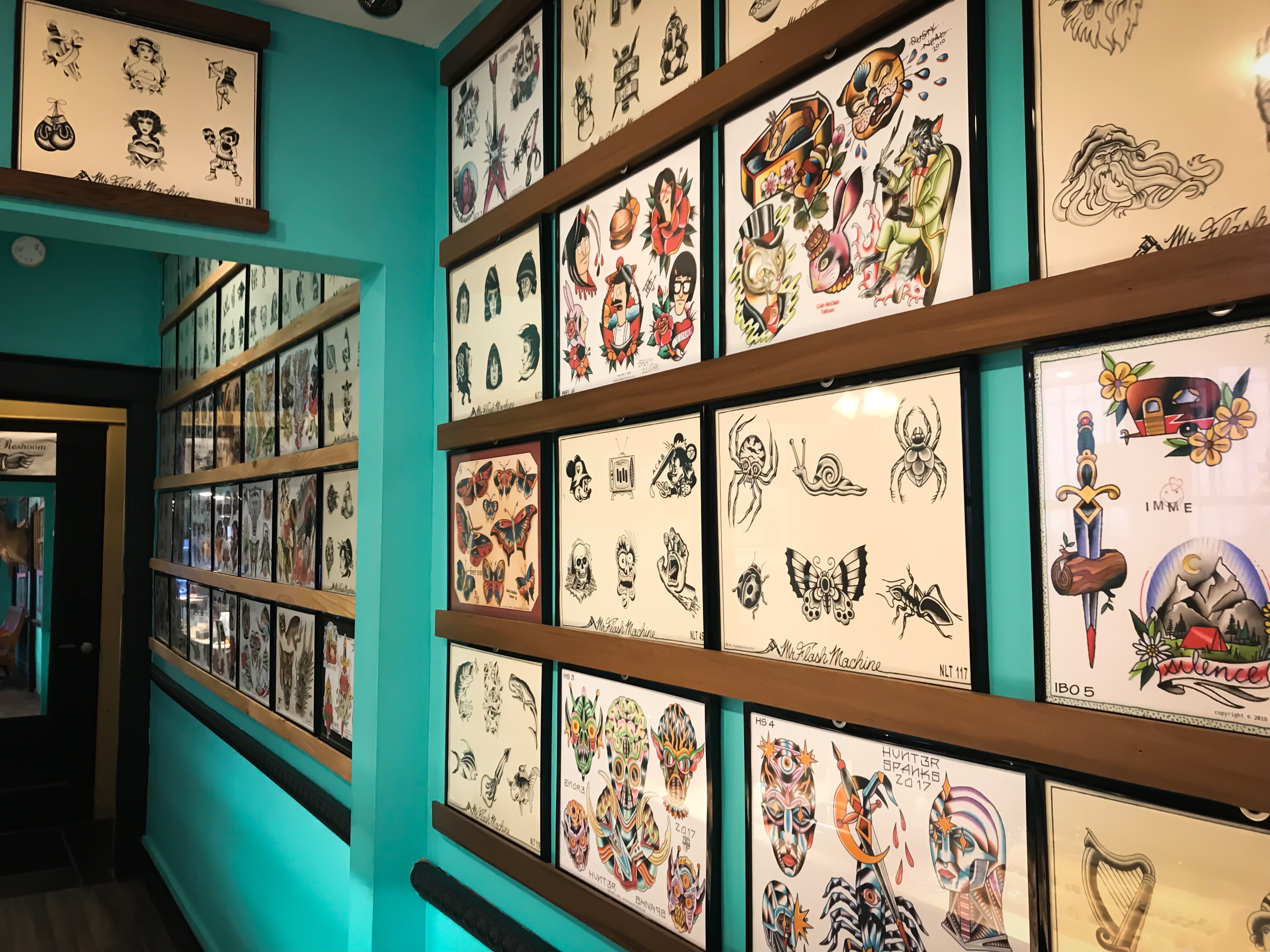 Flash lines the wall at Trilogy Tattoo and Piercing located at 530 South Highland Street in the University District. (Cole Bradley)