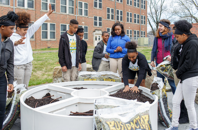 Students from Hamilton Middle School work in their school garden.