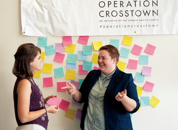 Terri Scott (left) and Dylan Sandifer discuss ideas that have been proposed for the Operation Crosstown initiative of the Church Health Center