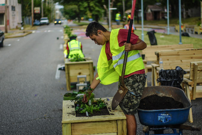 Volunteers installed planters that form a dividing wall to passing traffic on National Street.