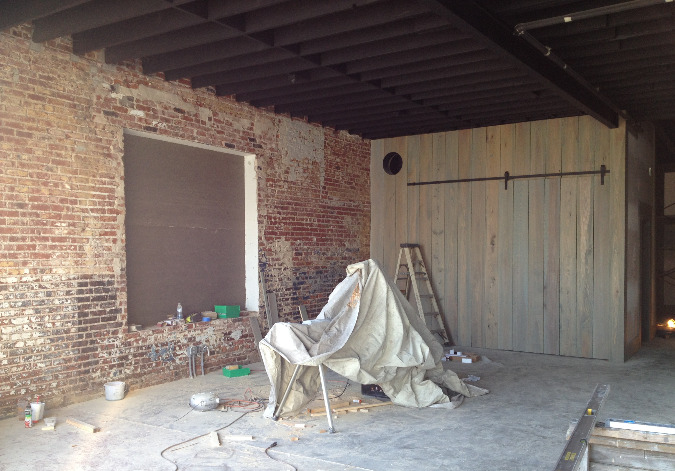 Exposed brick and stained wood highlight the interior of the adaptive reuse project.