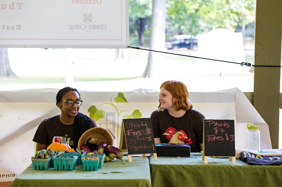 Vendors sell goods at a local farmers market. (High Ground News)