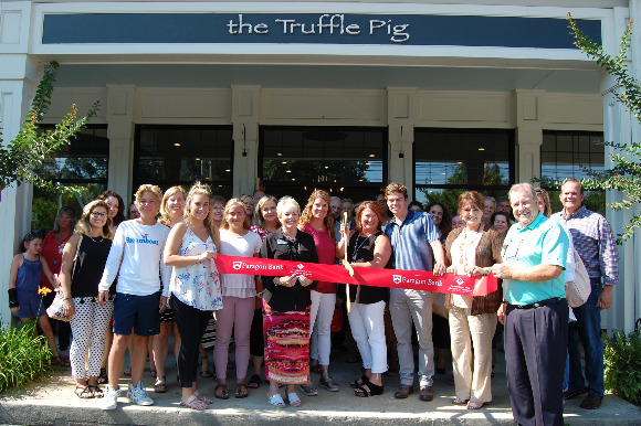 The Truffle Pig owners Tara  Gorman and Tricia Atkins (holding scissors) celebrate store opening.