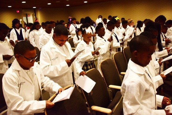 Nexus STEM Academy students wore emblems on their white coats representing their aspired careers. 