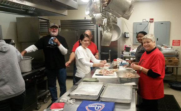 UBFM volunteers prep ingredients for the turkey and dressing Thanksgiving burritos