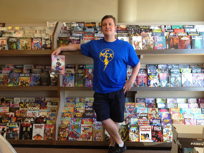 Memphis Comic Expo organizer Donnie Juengling holds a Shinobi comic by local creators Martheus and Janet Wade.