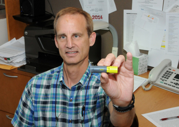 UTHSC's Dr. S. Casey Laizure  holds an Aeroshot caffeine inhalation device
