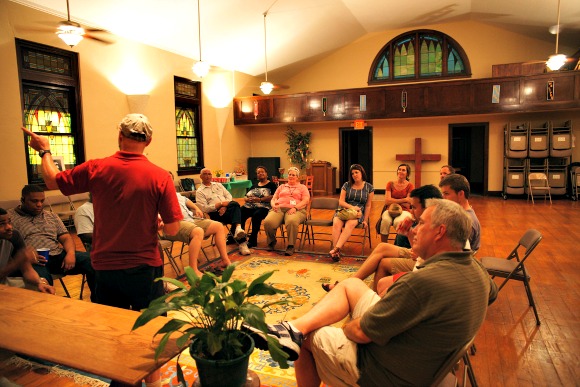 Billy Vaughan, center, speaks at the sancutuary of the Commons on Merton, a nonprofit support hub in Binghampton. (Bill Piacesi)