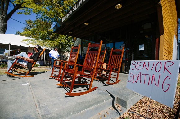 Festival volunteer sits in senior citizen section in front of Memphis Slim Collaboratory during the Soulsville Music Festival