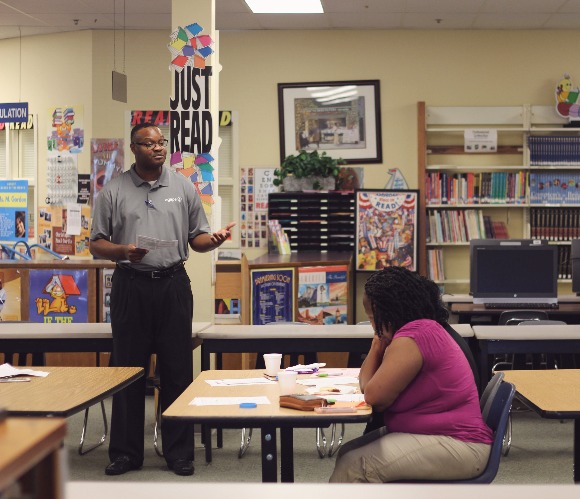 Agape team member Marquis McPherson talks to parents at Whitehaven's A. Maceo Walker Middle School about Agape's community and school-based services. (Submitted)