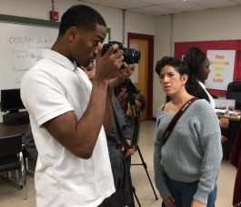 Andrea Morales, On The Ground photographer, instructs a Melrose High student in photo technique. 