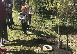 Neighbors and friends reflect on the life of longtime Vollintine-Evergreen resident and V&E Greenline leader, Jan Kirby. At the March 7 Arbor Day Celebration, those gathered installed a plaque and planted a tree in Kirby's honor. (Ashley Davis) 