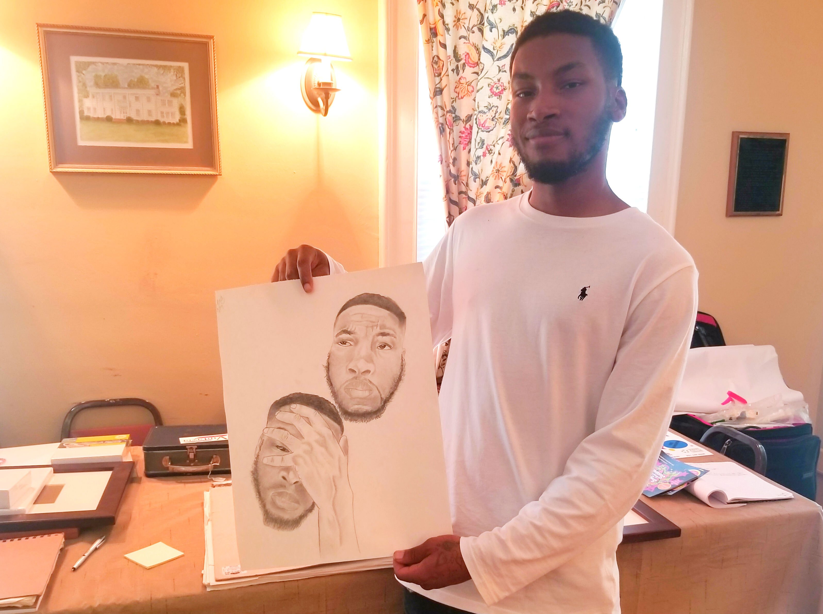 Raleigh resident Dre Morris shows off a work in progress that he will exhibit at the October 5 Frayser Local Arts Festival. (Arkwings Foundation)