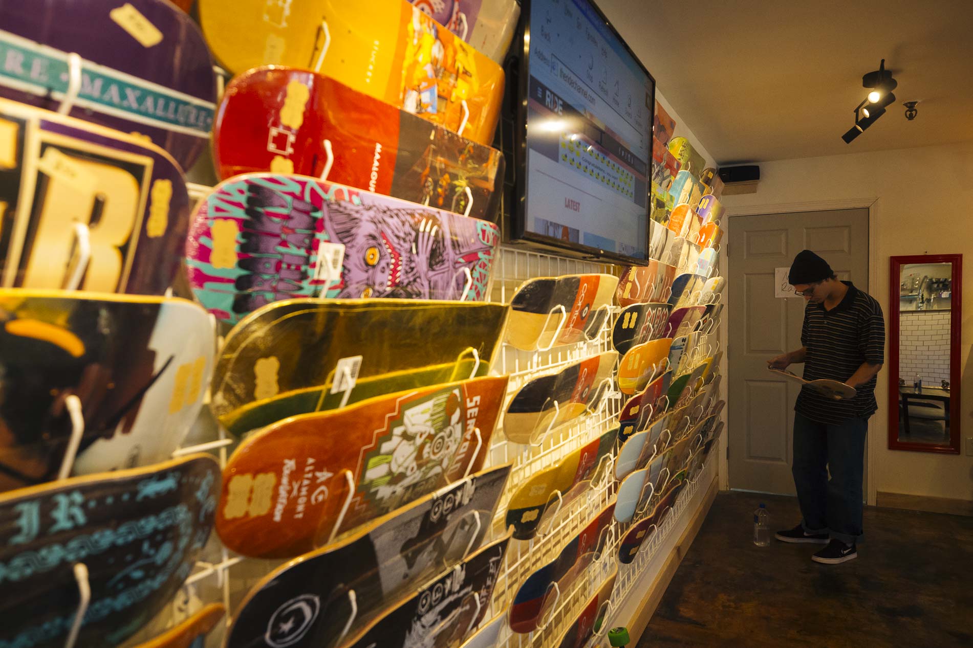 Skateboards line the walls of Contact Skateboard Shop inside Society Skatepark and Coffee. (Ziggy Mack)