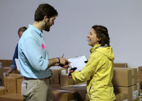 First Book representative, Miriam Keil, works with volunteers to ensure that all of the books reach their destinations.