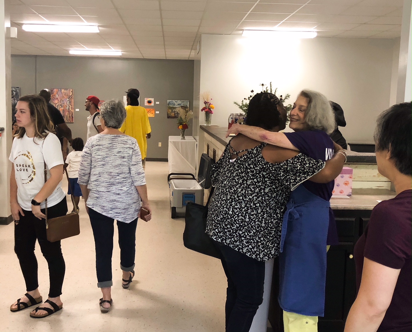 Eddie Thomas (R) hugs a neighbor. Thomas has been volunteering at Caritas for five years and says it's an opportunity to meet a cross section of Memphis. (Shelda Edwards)  