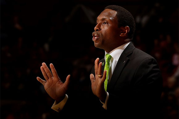 University of Alabama basketball coach Avery Johnson wears a green tie during a game to support literacy awareness. 