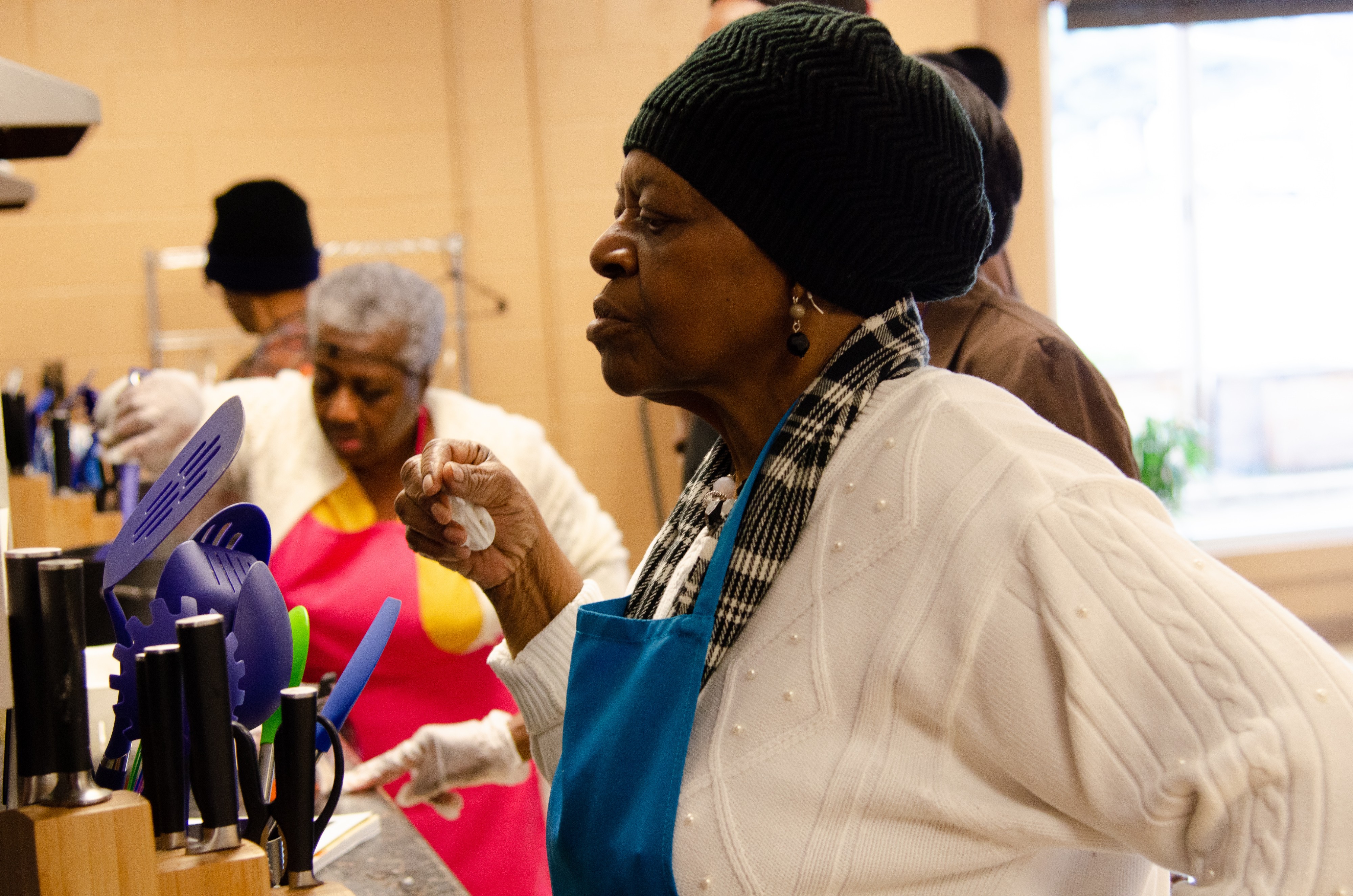 A student at the South Memphis community cooking class closely inspects her dish. (Cat Evans)