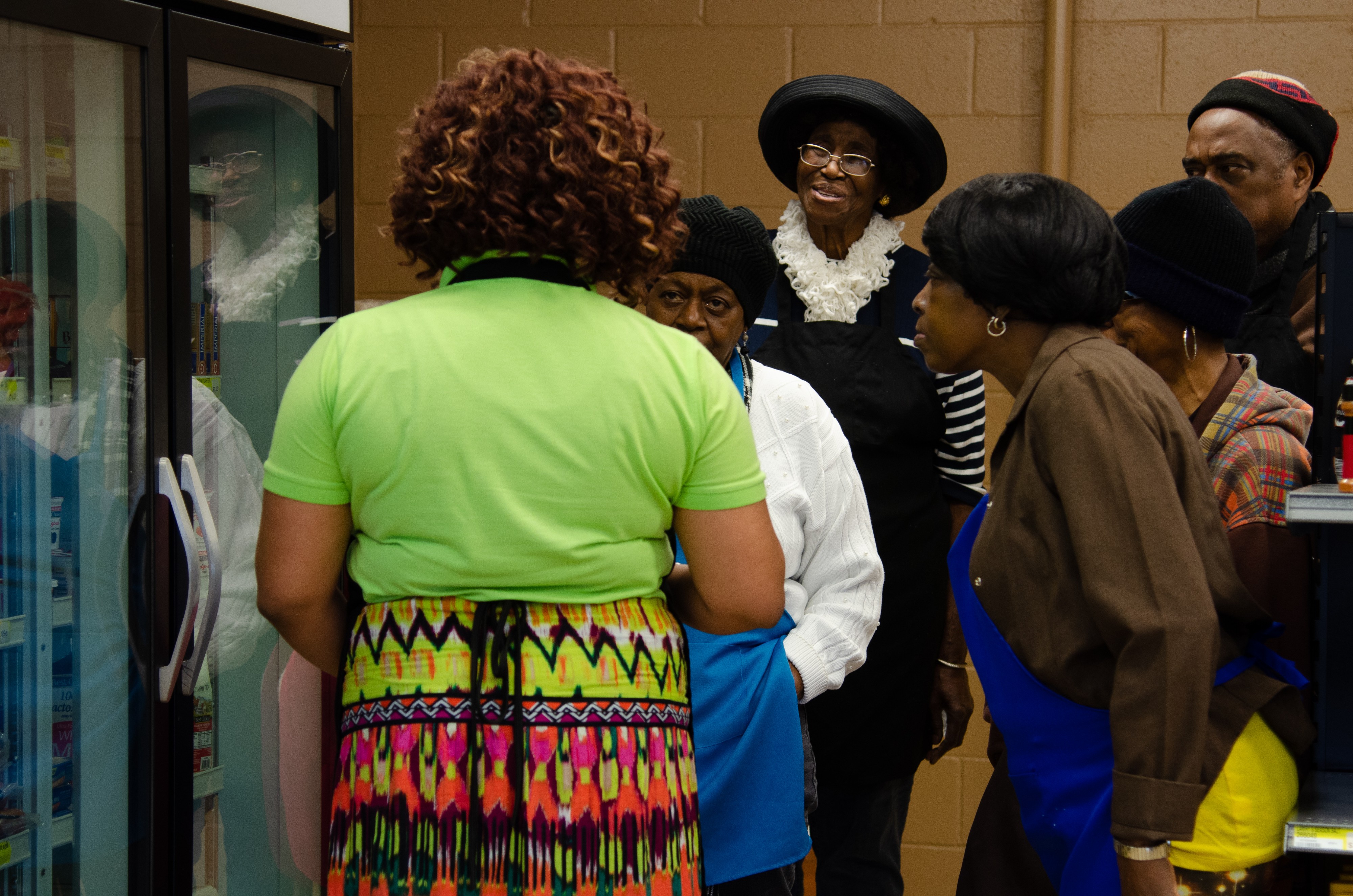 Cooking class instructor Karen Bernard (left) shows her students where to find ingredients at The Grocer. (Cat Evans)