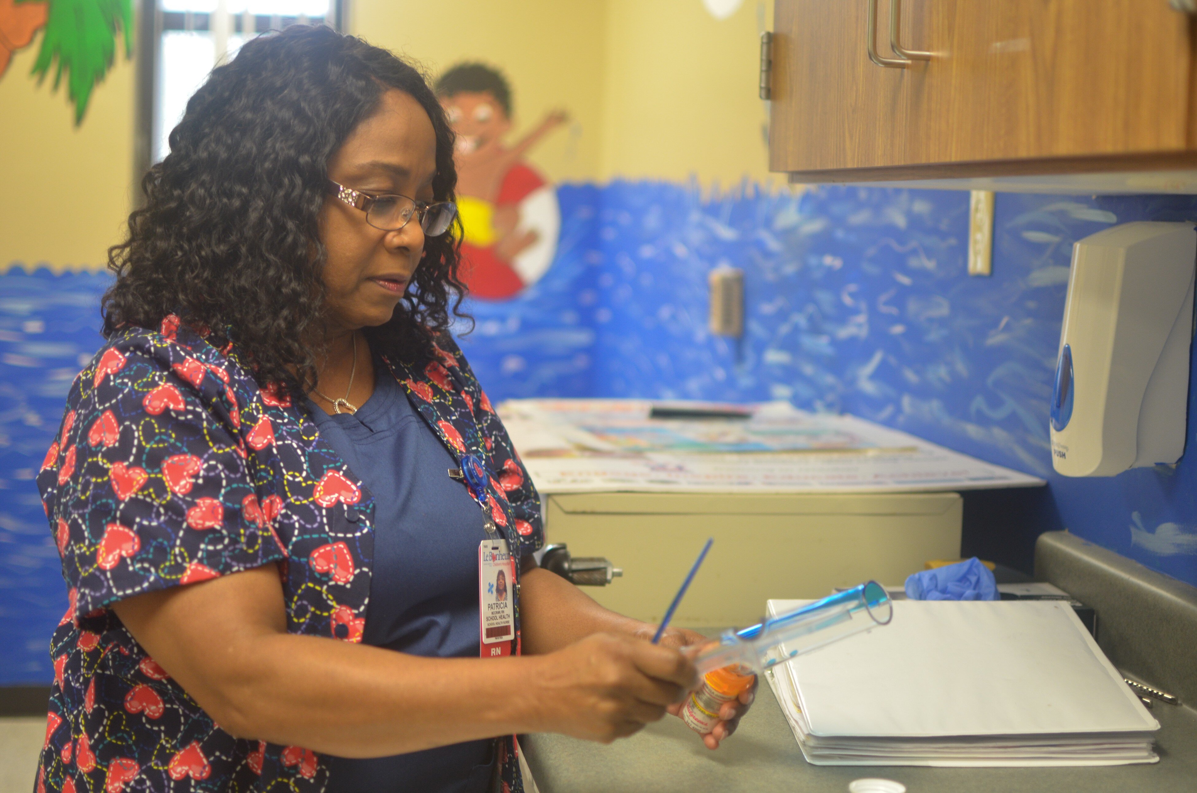 School nurse Patricia McCraw prepares medication for a student at A.B. Hill Elementary. McCraw is part of a school nurse pilot program facilitated by Le Bonheur Children's Hospital, Shelby County Schools and Urban Child Institute. (Cat Evans)