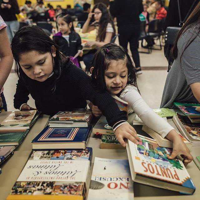 Children pick out a book at Desayuno Con Libros held monthly at Gaisman Community Center. (Desayuno Con Libros)