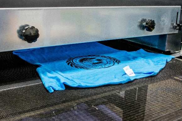 Printed t-shirts process in the dryer.