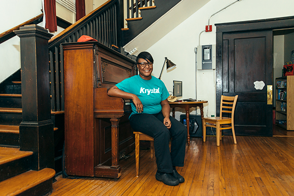 Daria Meeks sits for a portrait at her former residence, the Dorothy Day House. 