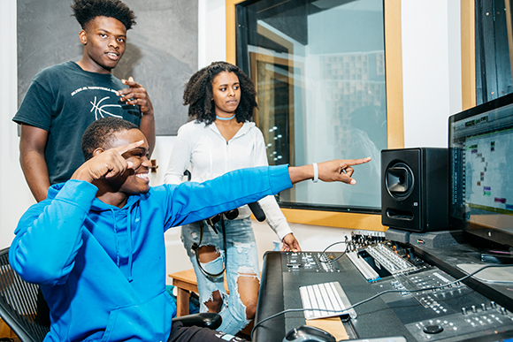 Walter Perry (center), Devonte Barner (left), and Nubia Yasin (right) collaborate on a song in Cloud901's recording studio.
