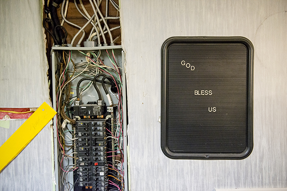 A fuse box and sign inside the future Eggxactly Breakfast and Deli restaurant. (Brandon Dill)