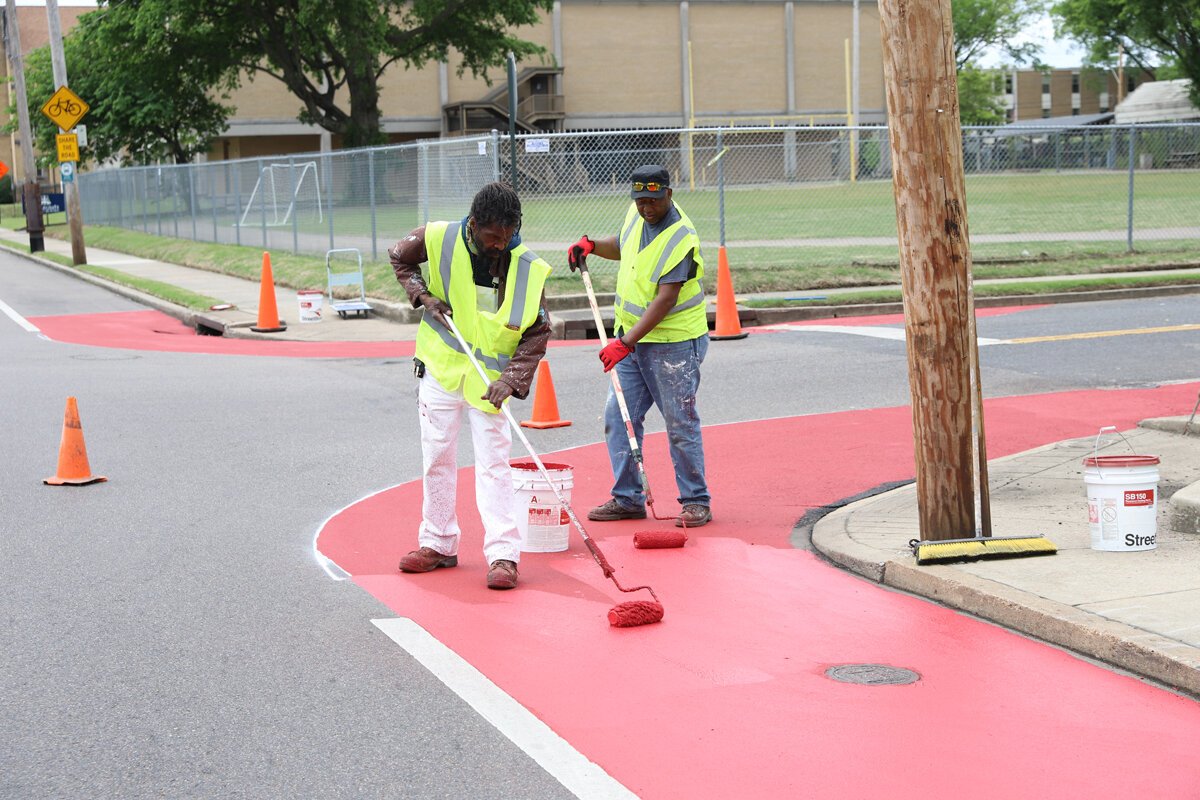 Crew members for the Heights CDC work on traffic calming features to complement the new bioswale construction at Tutwiler and National. (Reginald Johnson)