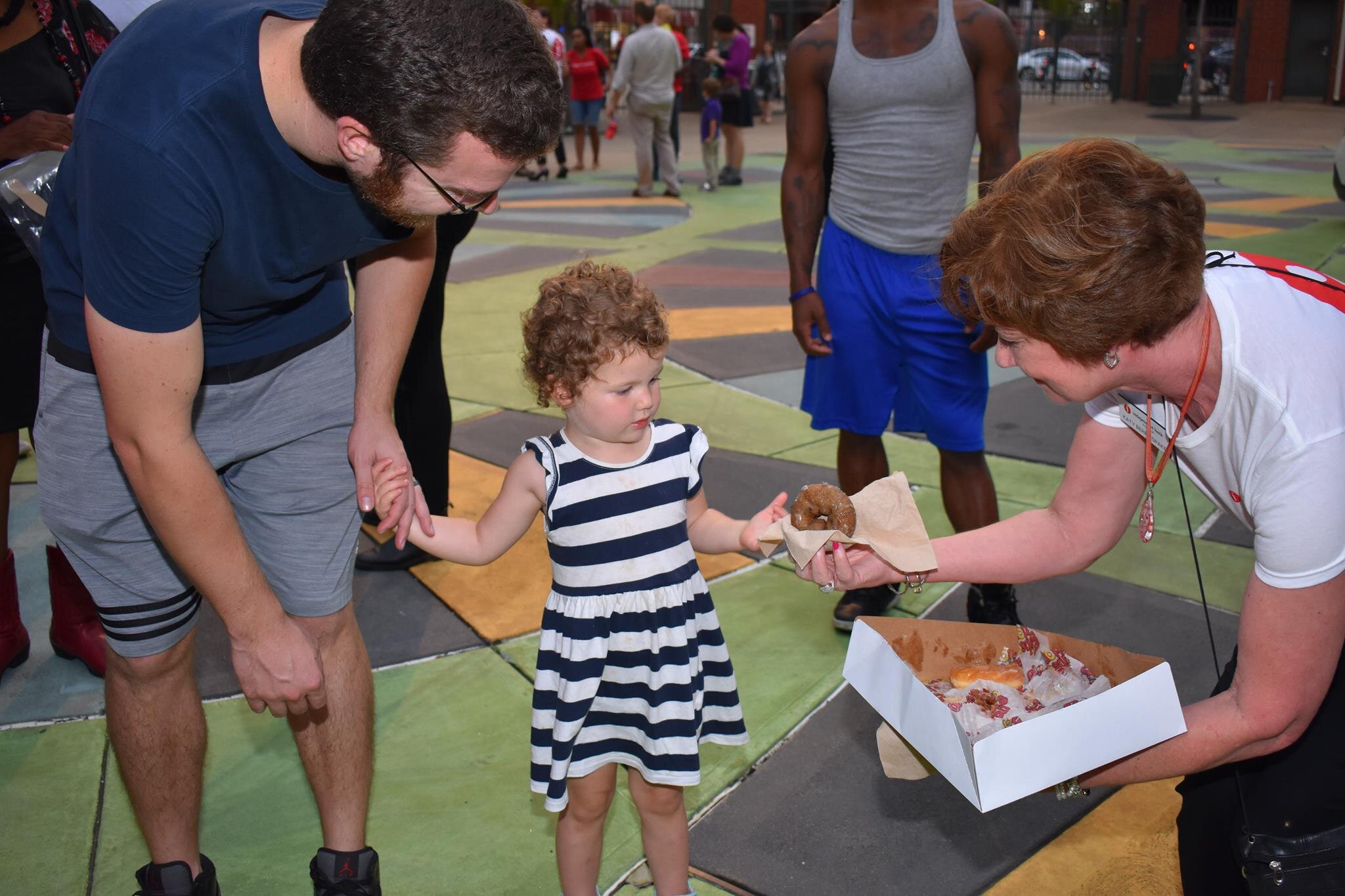 A young Memphian takes a sweet sample at a previous year's in-person Exposure held at AutoZone Park. (New Memphis)