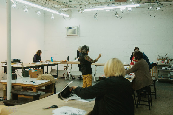 Susan Maakestad directs a collage class at the Flicker Street Art Studio.