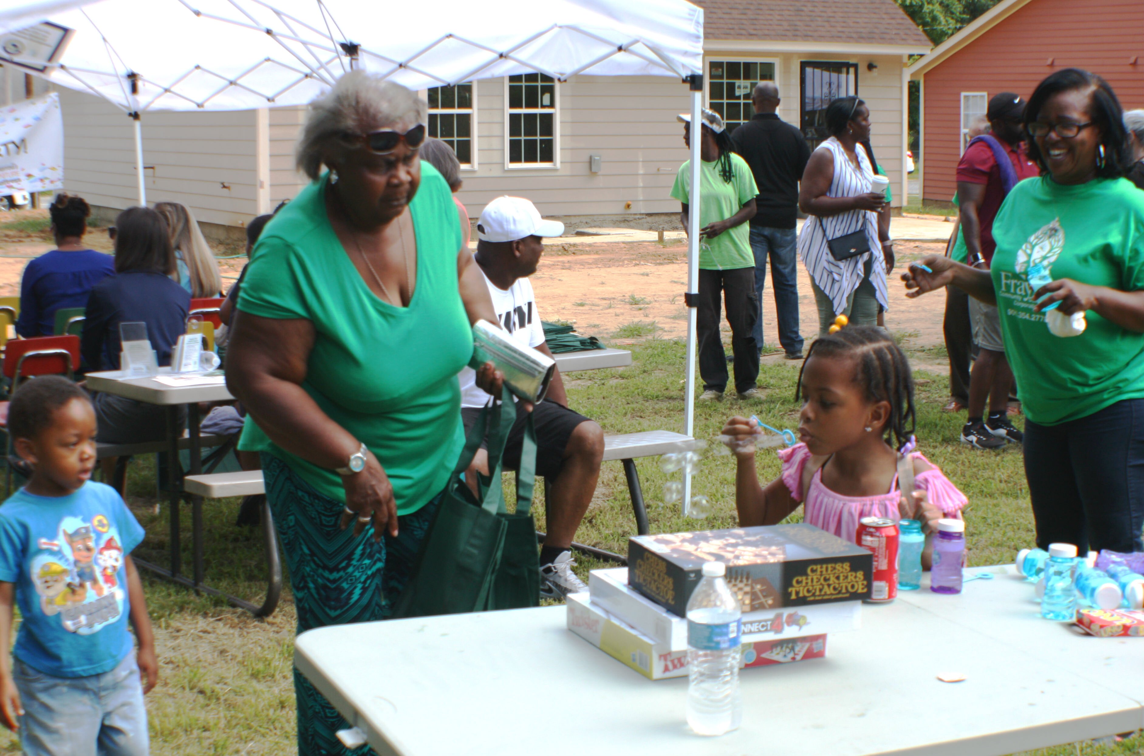The youngest guests at the Frayser CDC open house had plenty of bubbles and games to keep them busy while the adults celebrated the first new homes built by Frayser CDC in 10 years. (Cole Bradley)