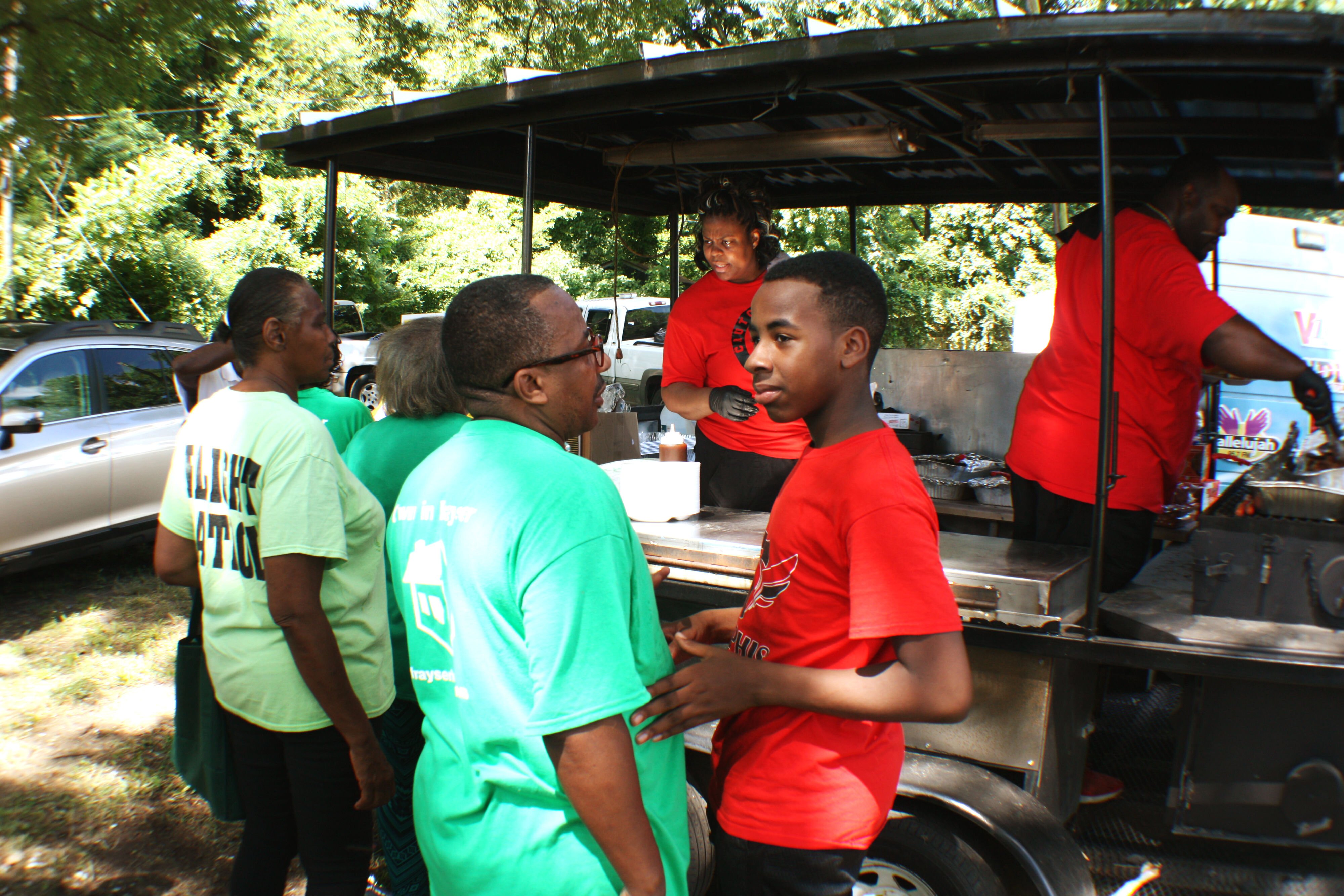 LaeKisha Crutchfield and Walter Crutchfield, Jr. cooked and served Crutchfields Bar-B-Q, including chicken wings, sides and pork sandwiches, to hungry guests of the Frayser CDC's open house. (Cole Bradley) 