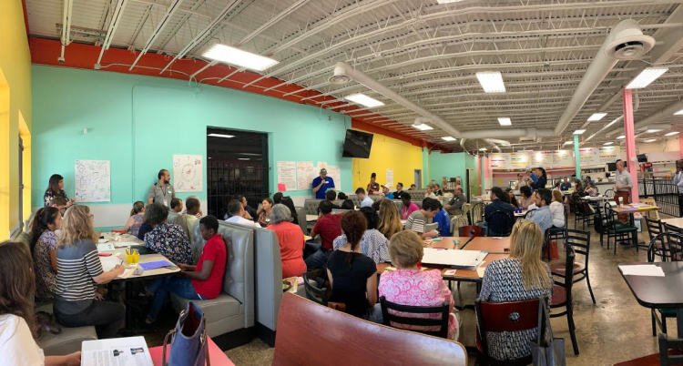 Attendees listen as breakout groups present findings at the first Gateway for Growth community meeting helped at La Michoacana Restaurant on the border between Berclair and The Heights. (Submitted)