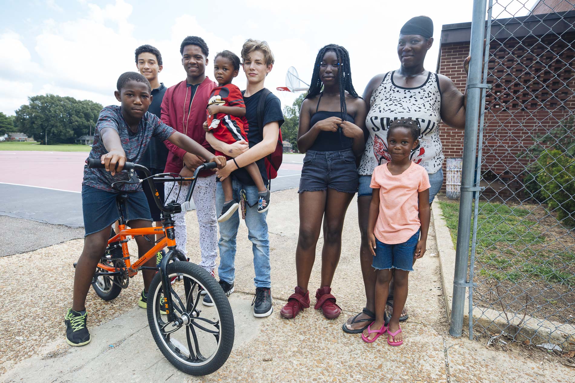 (Left to right) Ladarius Shields, Richy Phan, Ceric Hicks, Hayden Williams, London Johnson (held), Robin Tate, Alice Shields, and Lonel Shields (front) pose for a portrait at Treadwell Middle School. (Ziggy Mack)