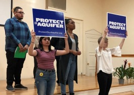 In a scene from the performance, cast members give an artistic re-enactment of neighbors joining together to oppose a proposed neighborhood landfill. From left to right: Michel Angel, Jazmin Bautista, Kierra Turner and Casey Greer. (Scarlet Ponder)