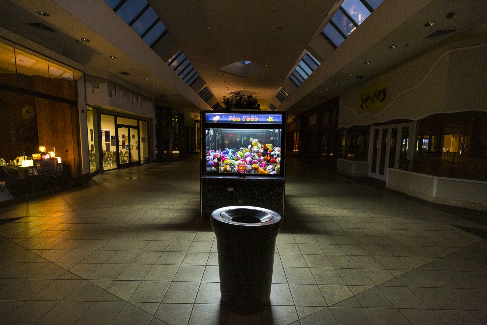 The light of a claw machine casts an eerie light down the hallway of the former Hickory Ridge Mall. The mall is now owned by World Overcomers Church, who are working to repurpose it as a town center. (Ziggy Mack)