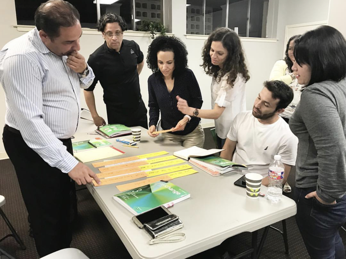 Students at an evening class at the World Relief Connect Language Center work on building sentences in a conversation. (Submitted)