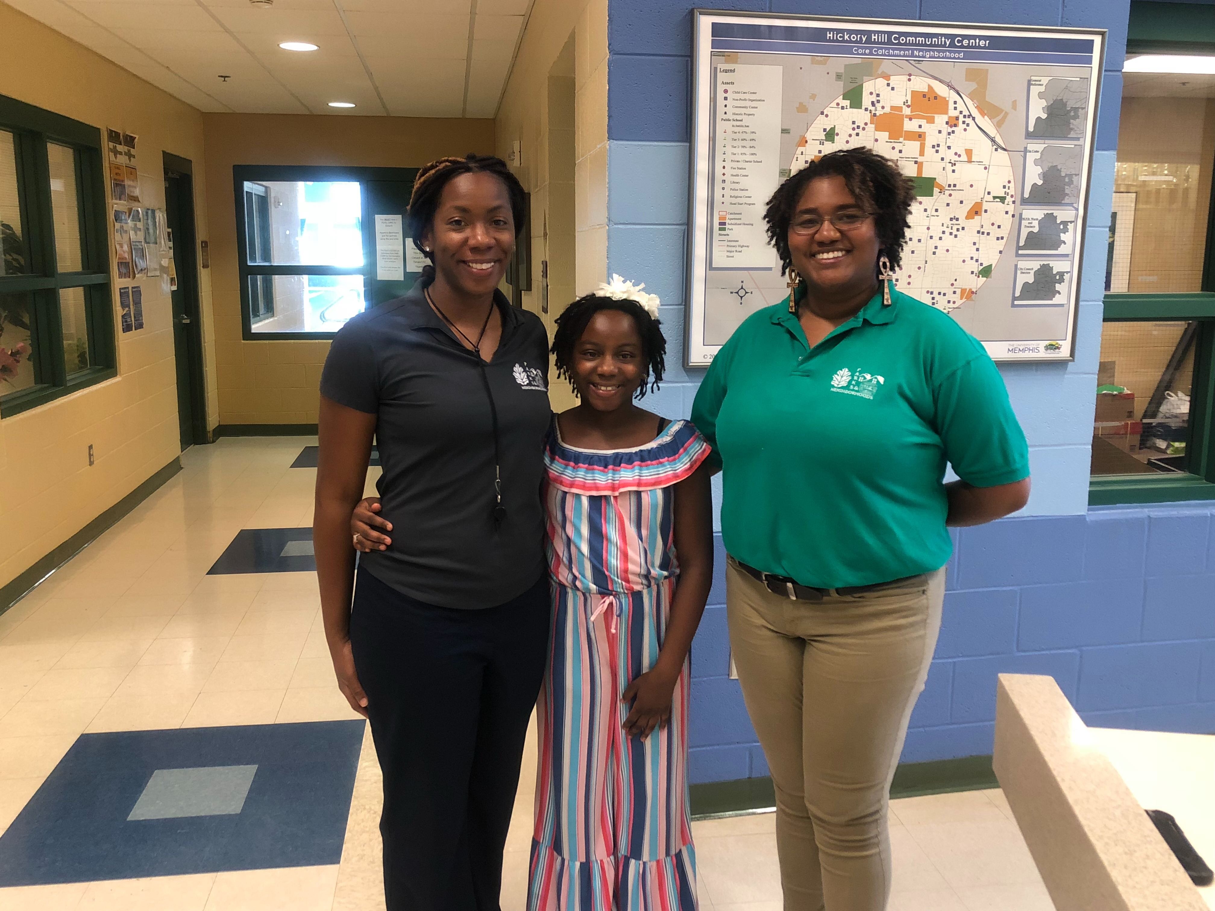 (L to R) Hickory Hill Community Center's assistant director, Danae Lawrence, her daughter and center volunteer, Mya Brady, and center director, Adrianna Moore pose in the center's lobby. (A.J. Dugger III)