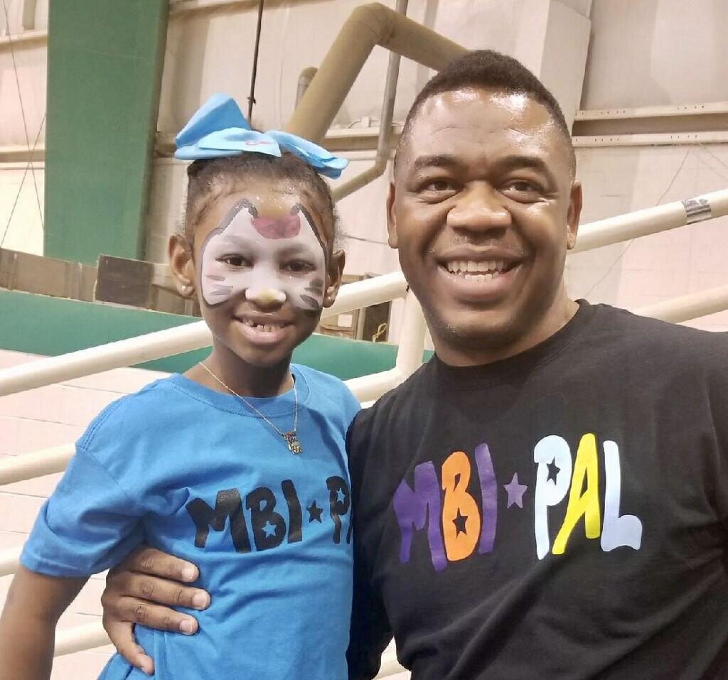 Craig Little, founder of the Sheriff’s & Police Activities League of Memphis & Shelby County, poses with a PAL youth at an event. (Submitted)