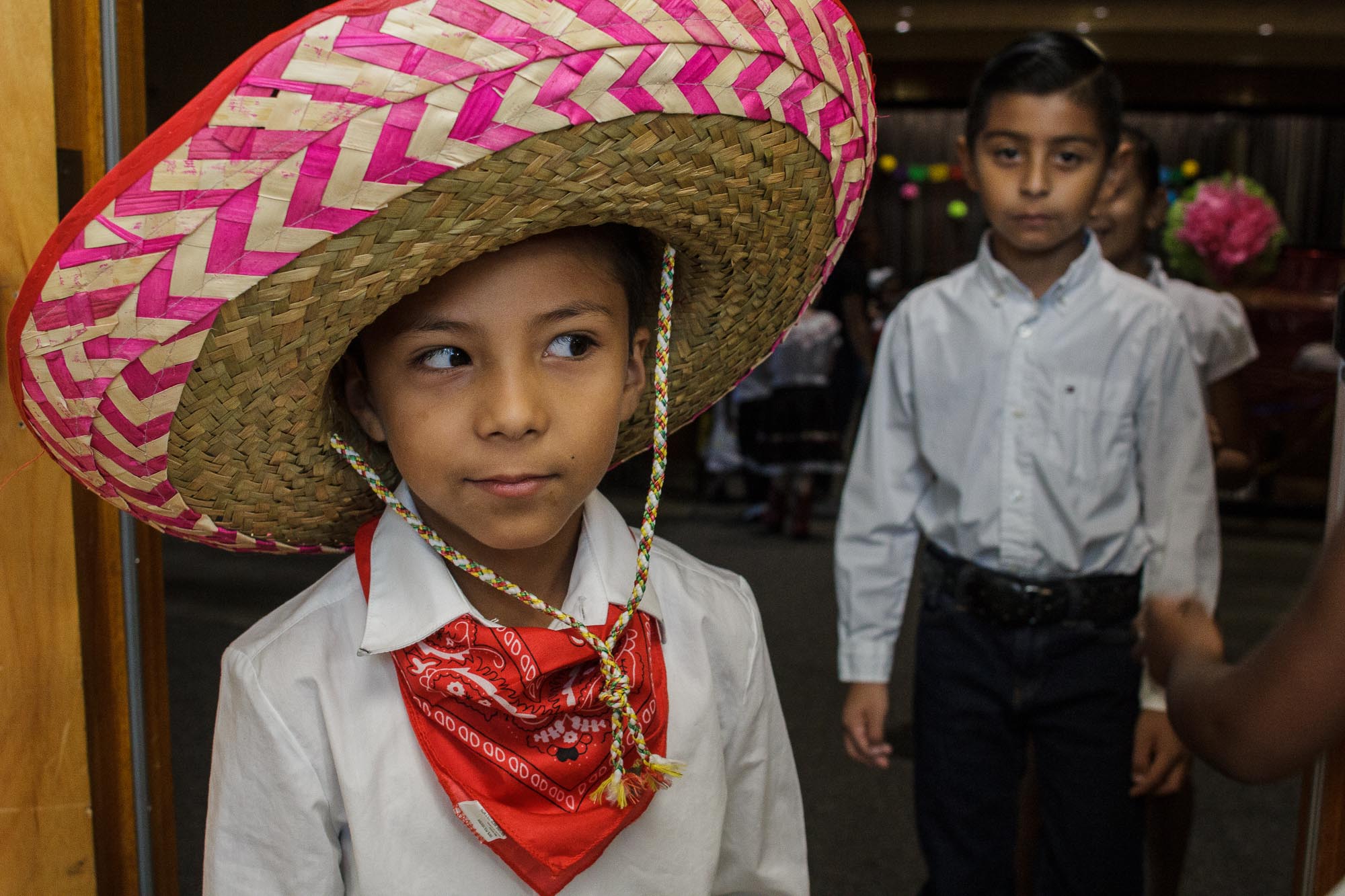 A first-grade student peeks around the corner at a pop-up performance held at Treadwell Elementary School as his classmates line up behind him. (Renier Otto)